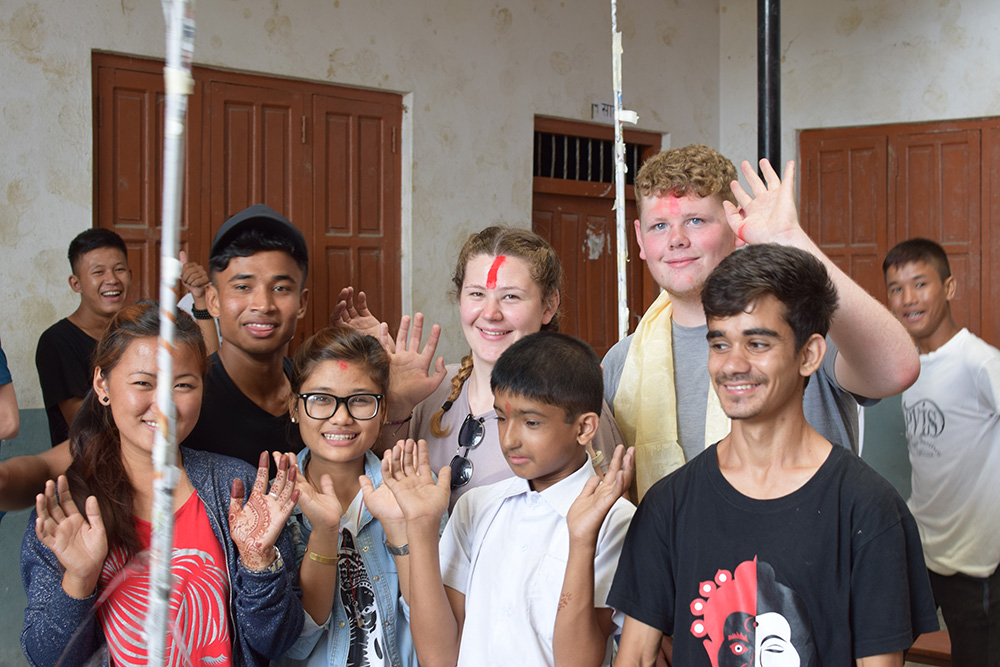 Ollie doing activities with local students during the Mary Hare School Nepal trip with VoluntEars