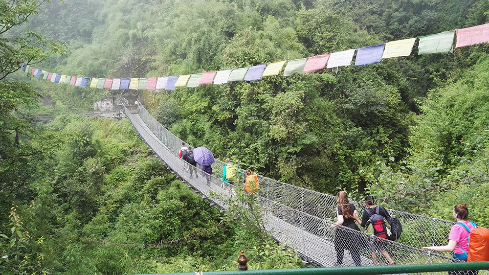 Sophie on a wire bridge in the mountains during the Mary Hare School Nepal trip with VoluntEars