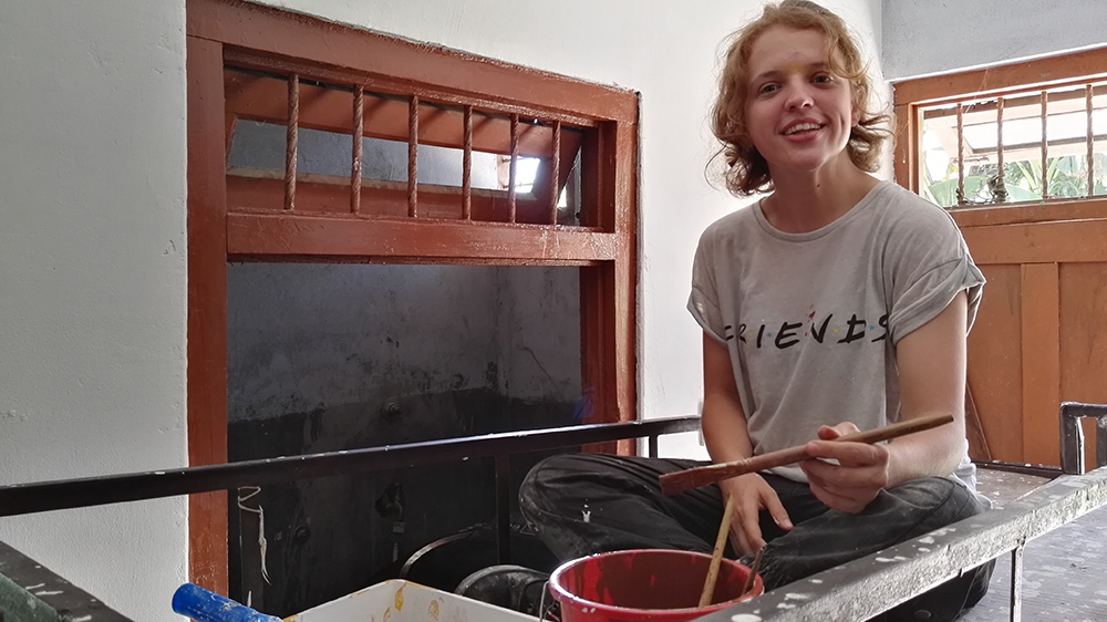 Katie helping to paint a Deaf school dormitory during her Nepal trip with VoluntEars