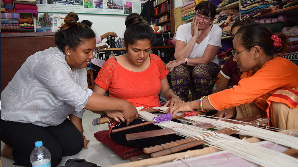 Hiral trying traditional weaving during her Nepal trip with VoluntEars