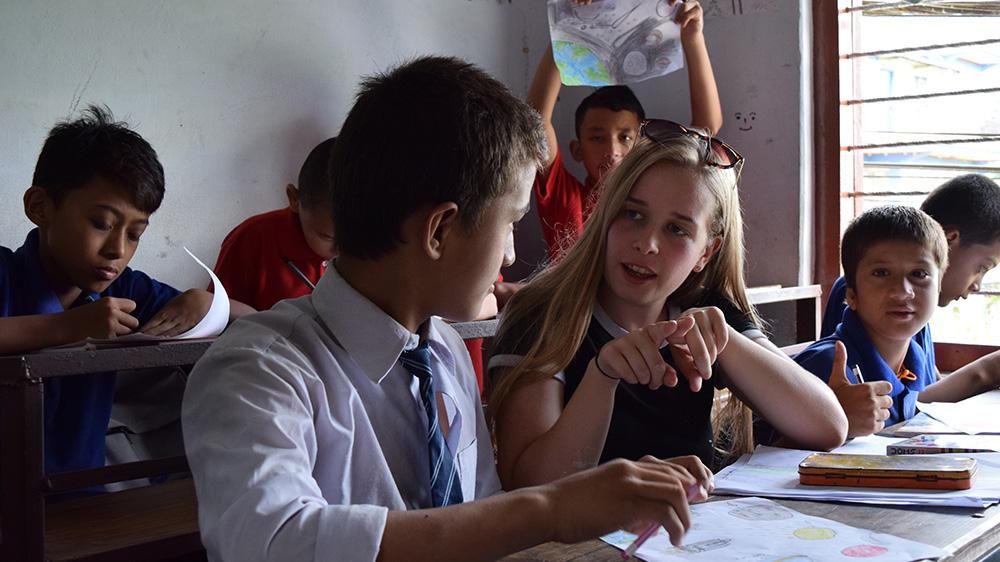 Leah helping in class during her Nepal trip with VoluntEars