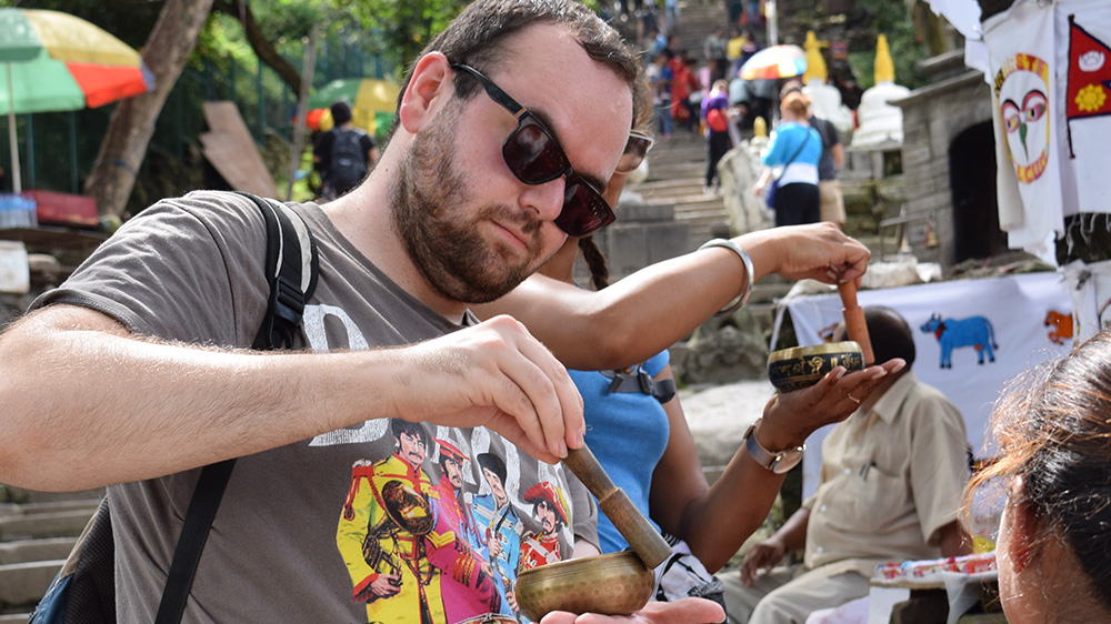 James using a "Singing bowl" during his Nepal trip with VoluntEars