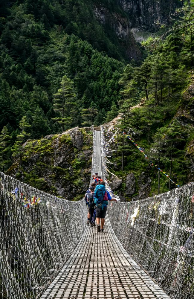 Crossing a bridge in the mountains on the VoluntEars Everest Base Camp trek
