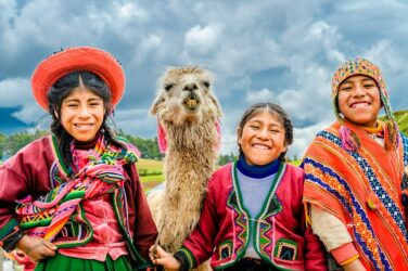 Children wearing traditional brightly coloured clothes in Peru