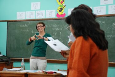 Female volunteer helping in a class in a deaf school in Peru