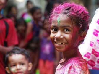 Indian girl with colourful powder on her face