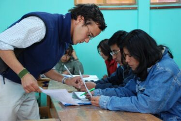 Male volunteer helping in a class in a deaf school in Peru